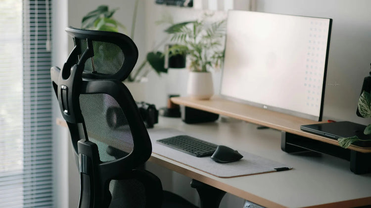 Photo of a mesh office chair in front of a computer desk