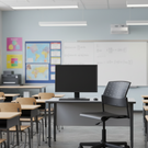 Modern classroom with desks, chairs, and a computer monitor.