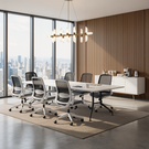 Modern conference room with large windows, chairs, and a table.