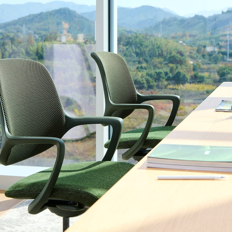 Load image into Gallery viewer, Two green office chairs in front of a large window with a scenic view.
