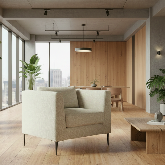 Modern living room with beige armchair, wooden coffee table, and large windows.