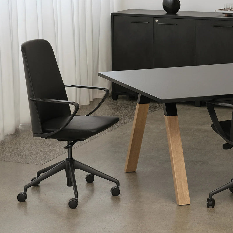 Load image into Gallery viewer, Modern office setup with black chairs and a wooden table.
