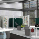 Modern office space with green partition walls and white desks.