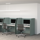 Modern office setup with computer stations and chairs in a minimalistic office space.