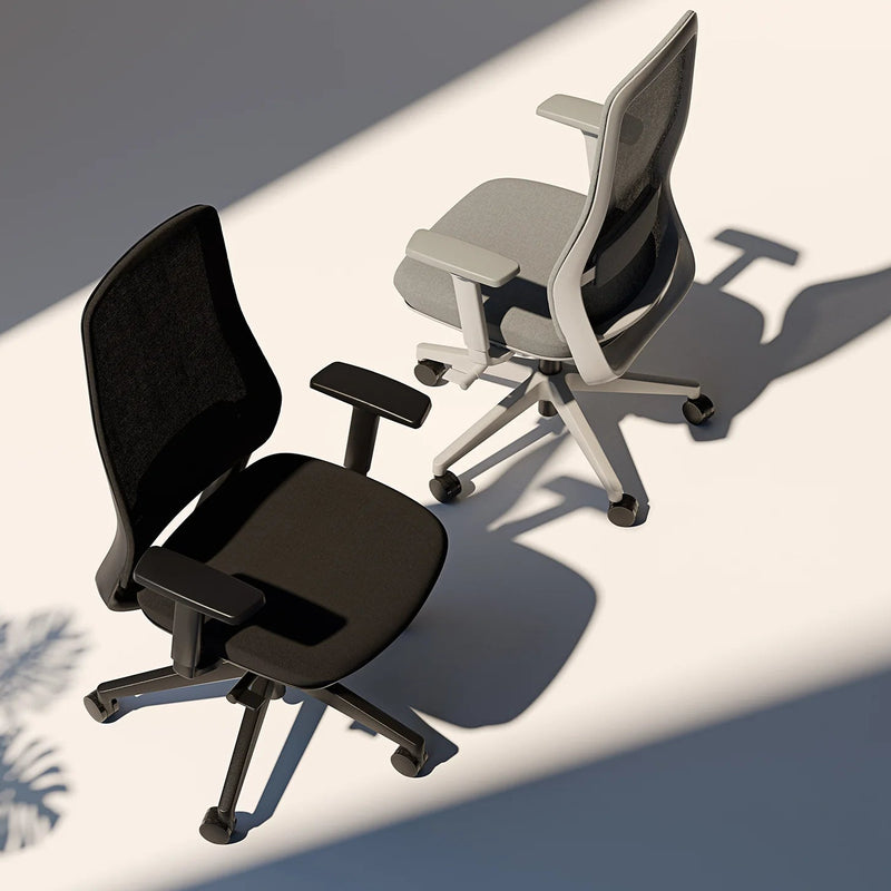 Load image into Gallery viewer, Two office chairs, one black and one gray, on a reflective surface with shadows.
