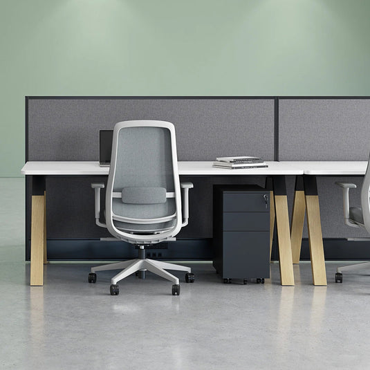 Modern office setup with desks and chairs in a minimalistic office space.