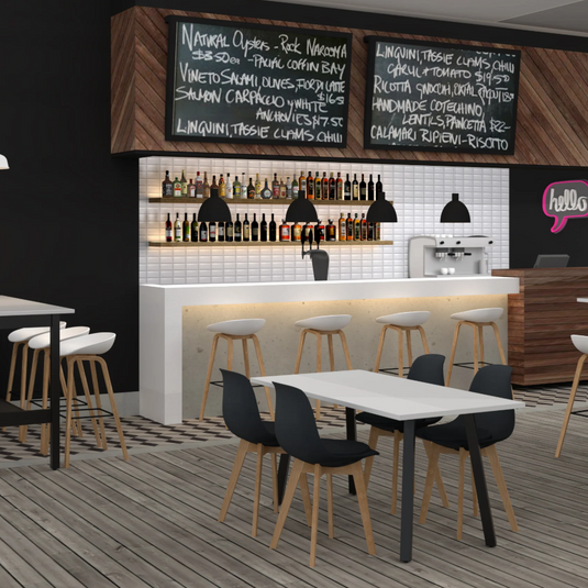 Modern restaurant interior with tables, chairs, and a bar area.