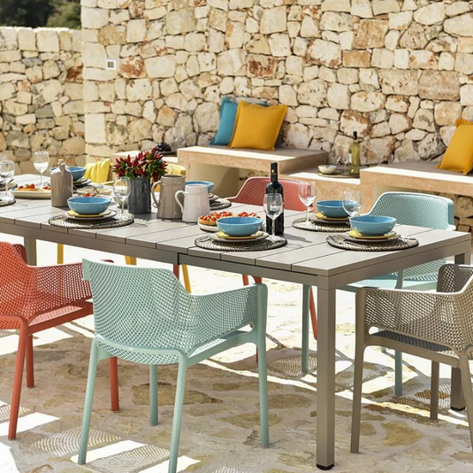 bright colored outdoor chairs and extendable table