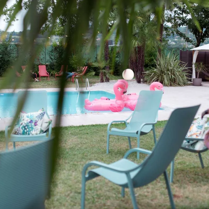 Load image into Gallery viewer, mint outdoor lounge chairs and pool with flamingo's 
