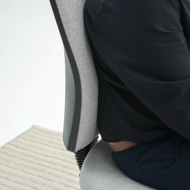 Load image into Gallery viewer, Person sitting on a gray office chair with a blurred background
