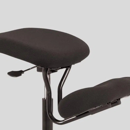 Black ergonomic office chair with adjustable backrest on a light gray background