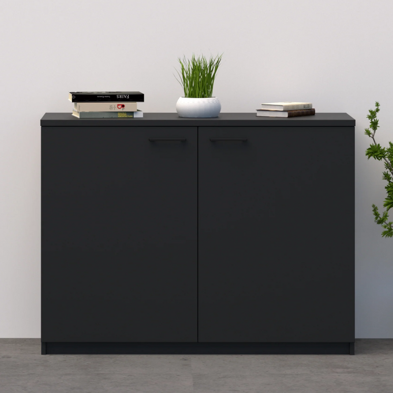 Load image into Gallery viewer, Black cabinet with decorative items against a white wall

