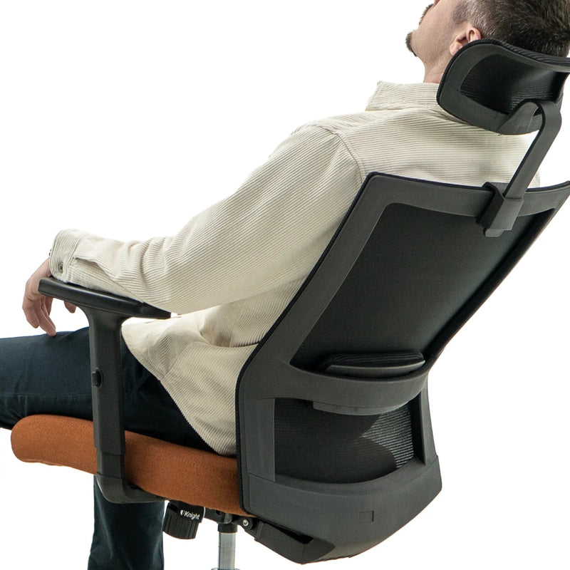 Load image into Gallery viewer, Person sitting on a ergonomic office chair with a white background

